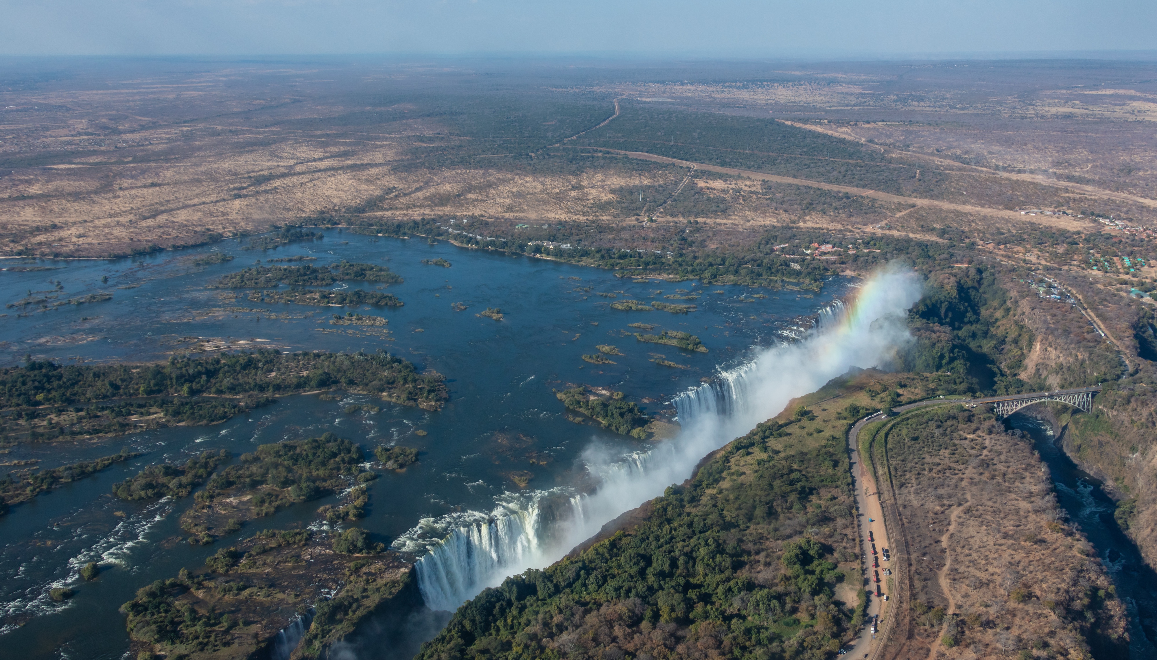 Aerial panorama of Victoria Falls, the Zambezi River and the bridge into Livingstone